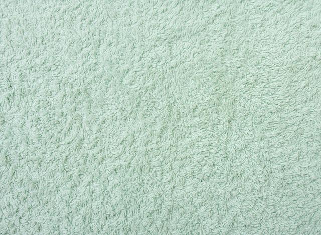 A turquoise green woollen colour carpet