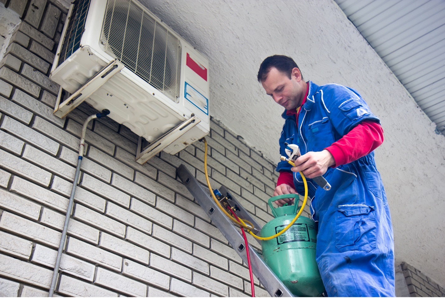 Man troubleshooting and repairing the air conditioner.