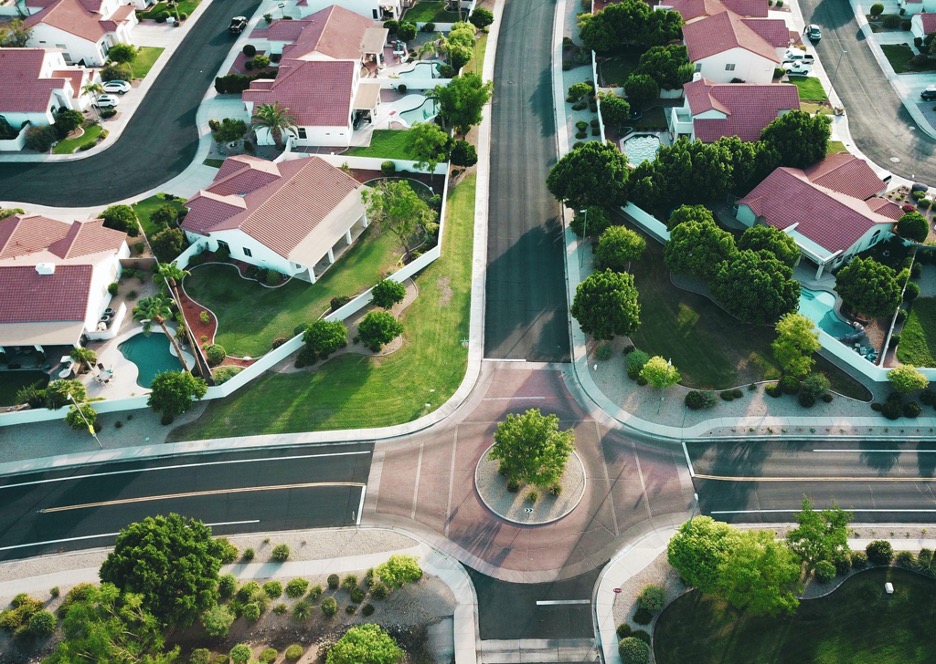 A new city location surrounded by lush green trees.