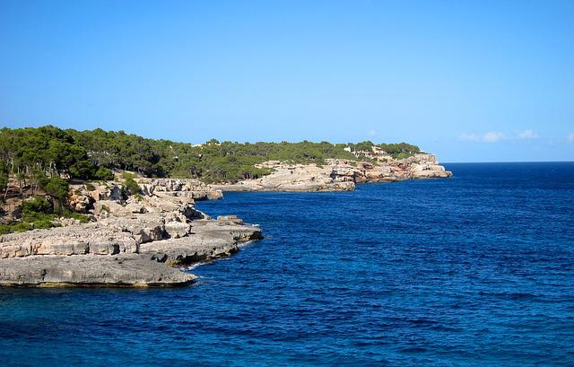 A beautiful island with dark blue sea and trees around.