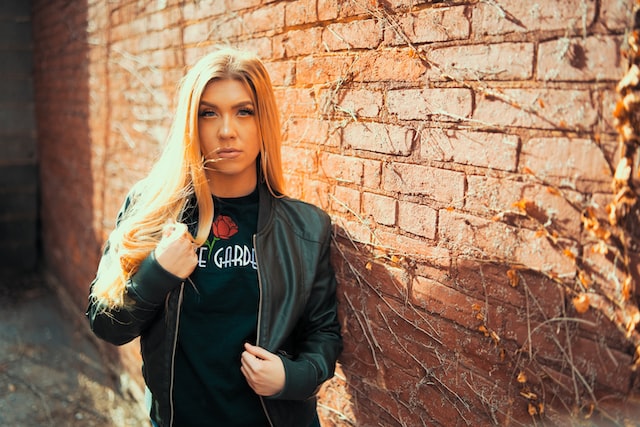 A woman in black leather jacket.