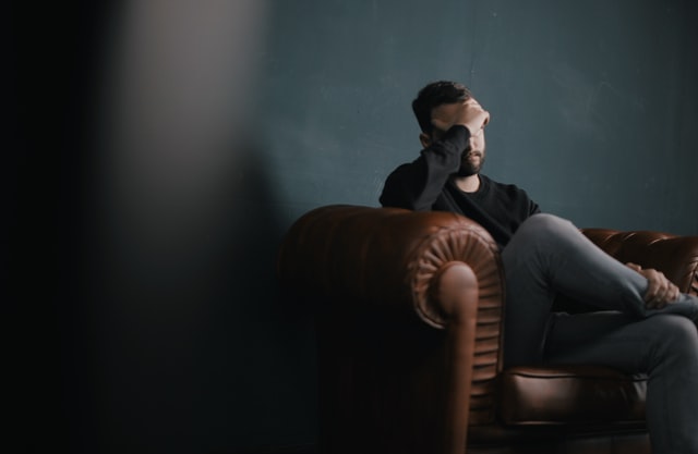 Man holding his head due to Mental Health Disorders.