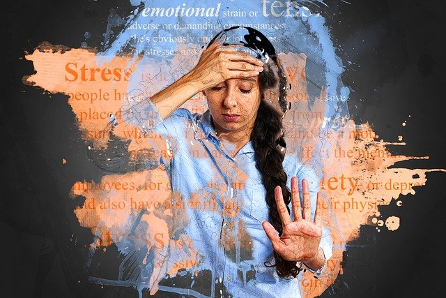 A woman completely stressed out and is holding her head in Depression.