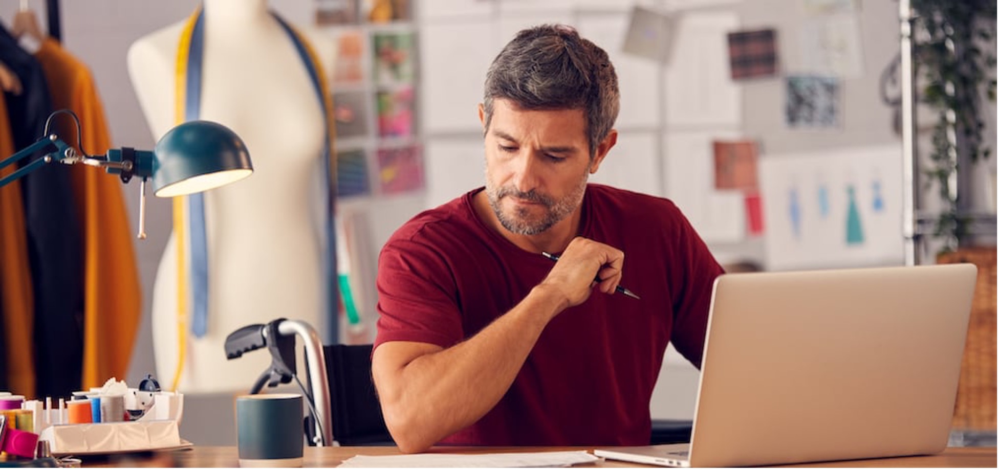 A man holding a pen looking into papers.