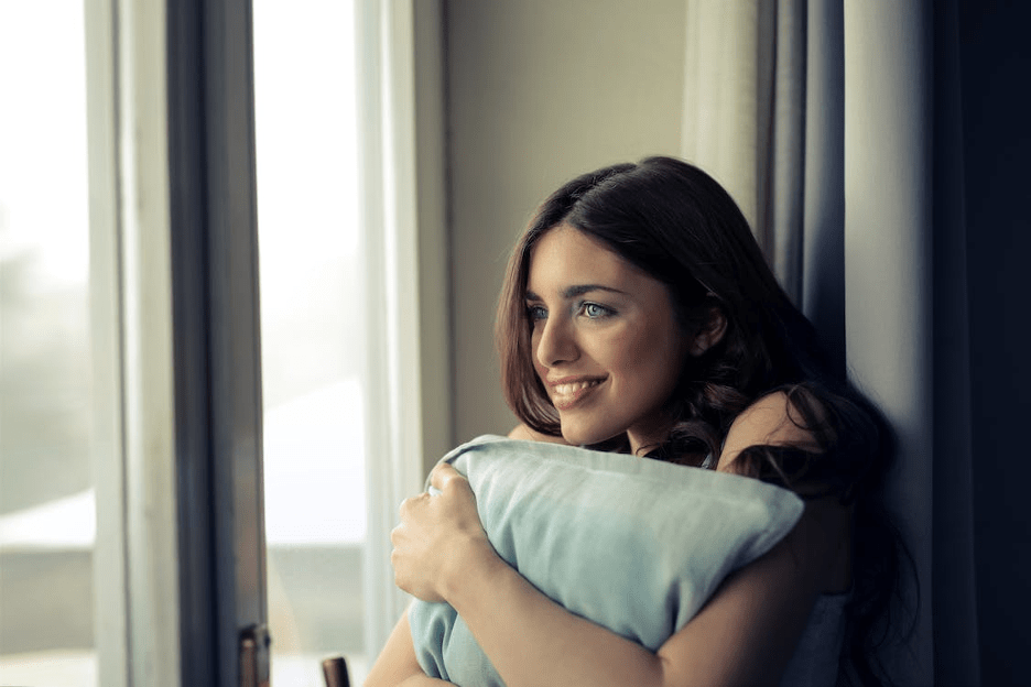 A woman hugging a pillow.