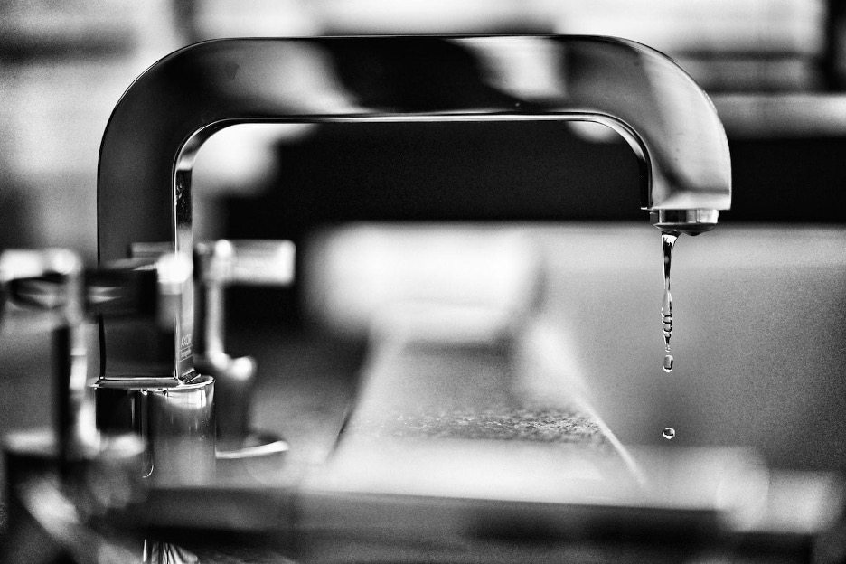 Water leaking out from a tap.