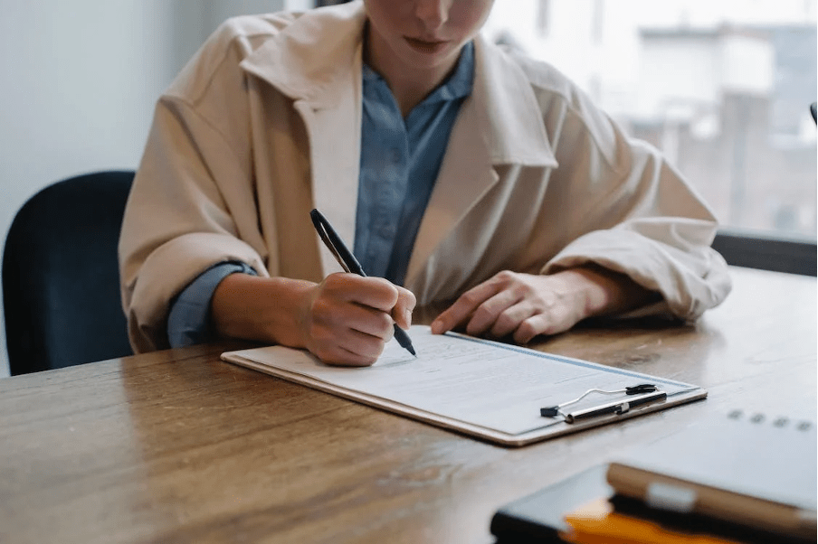 A woman filling up an application form for Nurse.