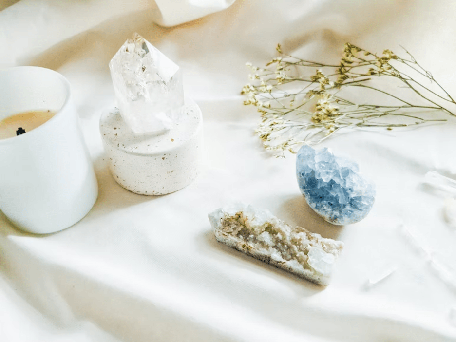 A blue and white gemstone and a candle placed on the table.