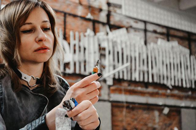 A woman holding a syringe in her hand.