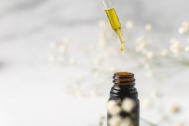 CBD oil drops been dropped in a bottle.