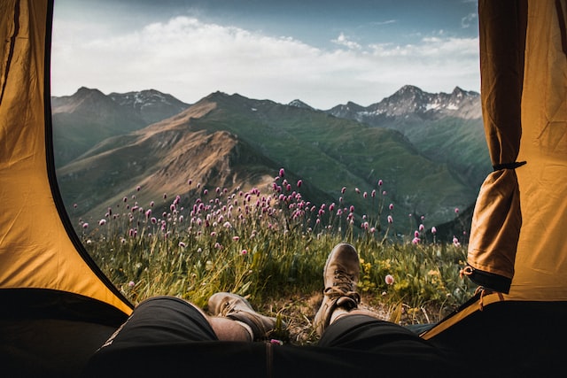 A man in his tent enjoying the scenery.