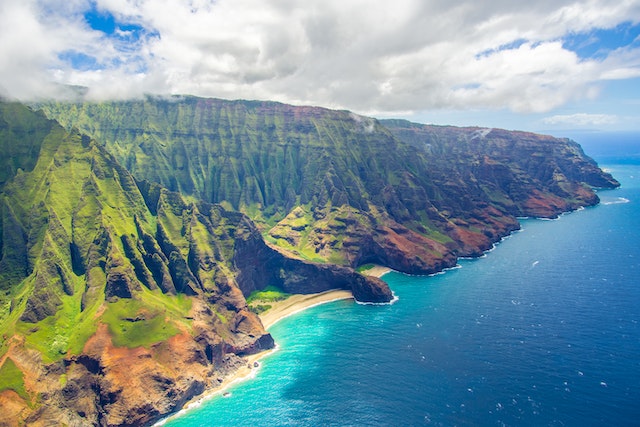 A blue sea surrounded by greenery.