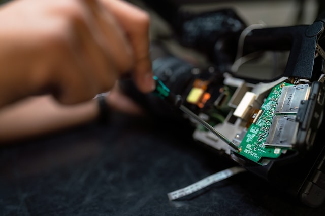 A man repairing an electrical part.