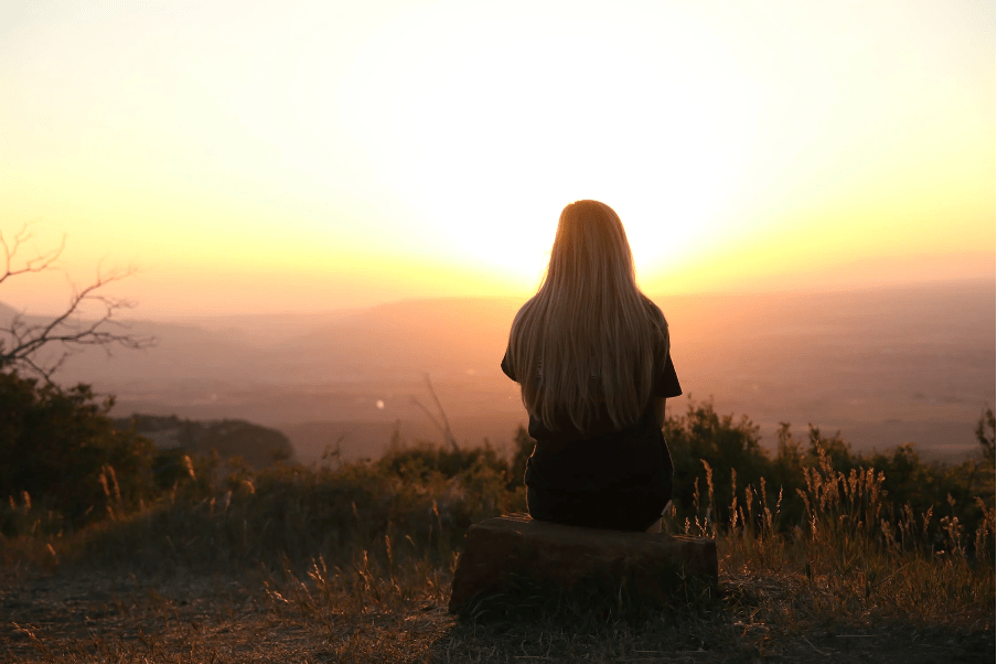 Woman looking at the sun rise.