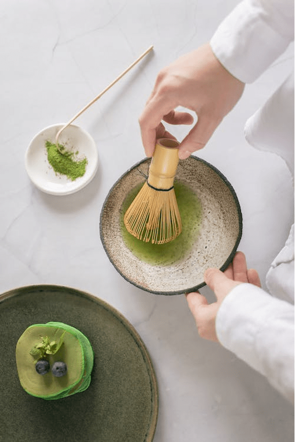 Man mixing green powder.