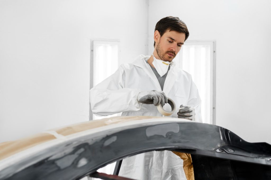 male-painter-using-gun-paint-car-shop-1024x683